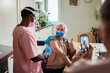 © Marko Geber - Senior man receiving COVID-19 vaccine at home
