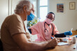© Marko Geber - Nurse talking to senior patient during home visit