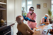 © Marko Geber - Home healthcare worker doing covid swab test to elderly man with wife watching