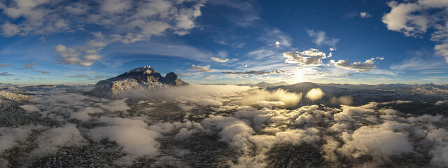 Wall Mural - Dramatic Aerial Panorama of Clouds and Mountain Landscape. Nature Background.