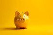 Yellow piggy bank on a matching yellow background. Savings and financial concept.