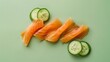 Smoked salmon slices with lemon and cucumber on a green background. Flat lay composition with copy space. Gourmet seafood concept for design and print.