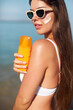 Woman smile applying sun cream on face. Skincare. Body Sun protection. sunscreen. Female smear moisturizing lotion on skin