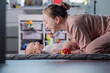 Young mother talks and plays with her baby son while lying on her back. Baby care, motherhood concept