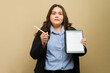 Plus-size businesswoman holding a digital tablet displaying a document, ready to explain its contents