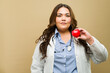 Plus-size female doctor holds a red heart, symbolizing care and cardiovascular health