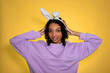 easter banner with happy smiling african american girl in eater bunny ears. Studio shot. Place for text