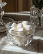 Macro photography of white sugar cubes arranged neatly in a transparent glass sugar bowl