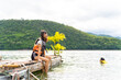 © CandyRetriever  - Young attractive Asian woman with life vest swimming and playing water in the lake. Happy generation z girl enjoy and fun outdoor lifestyle travel nature lake house on summer holiday vacation.