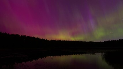 aurora borealis over a lake in port orchard washington on may 10th, 2024 during the largest geomagne