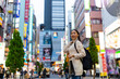 © CandyRetriever  - Happy Asian woman holding shopping bag walking at Shibuya district, Tokyo, Japan in evening. Attractive girl enjoy and fun outdoor lifestyle travel urban city street and shopping on holiday vacation.