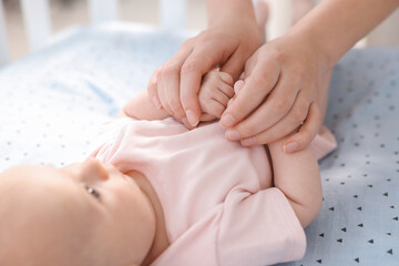 Wall Mural - Mother with her cute little baby in crib