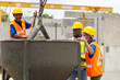 © JU.STOCKER - Foreman and worker team checking project at the precast factory site, Engineer man and builders in hardhats discussing on construction site