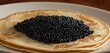 Pancakes with caviar for breakfast highlight luxury morning meal. Golden stack of thin pancakes or blini topped with black caviar