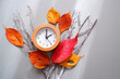 Daylight Saving Time concept background. 
Fall Back decoration colorful leaves and clock composition on gray background. 