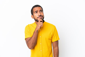 Wall Mural - Young Ecuadorian man isolated on white background and looking up