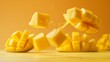 © Photo Ground - Dynamic image of fresh mango cubes in mid-air, splashing juice against a vivid yellow background, highlighting tropical freshness.