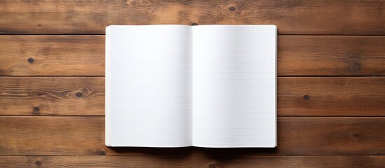 Poster - A copy space image of a blank page in an open notebook seen from a top down perspective resting on a wooden table