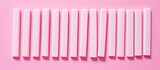 Fototapeta  - A flat lay of delicious chewing gum sticks arranged on a pink backdrop providing ample space for accompanying text