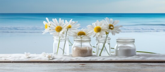 Sticker - On the table there are three banks containing sea salt and flowers creating a copy space image