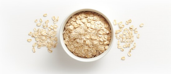 Wall Mural - A bowl of oats and oatmeal placed on a plain white surface with space for copy around the image. Creative banner. Copyspace image
