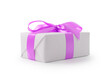White gift box with purple ribbon bow isolated on white background