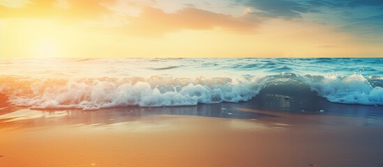 Aufkleber - Blurry tropical sunset beach with the bokeh effect of sunlight on the waves creates an abstract background The image allows for copy space representing an outdoor summer vacation and travel adventure