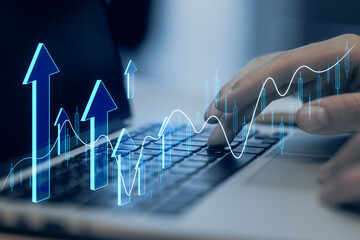 Close up of male hand using laptop with creative growing forex chart with arrow on blurry background. Financial growth and stock concept. Double exposure.