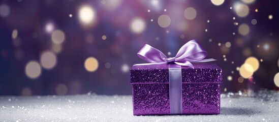 A gorgeous holiday gift box with a shiny purple package adorned by a silver ribbon perfect for Christmas and New Year The background offers plenty of copy space for adding text