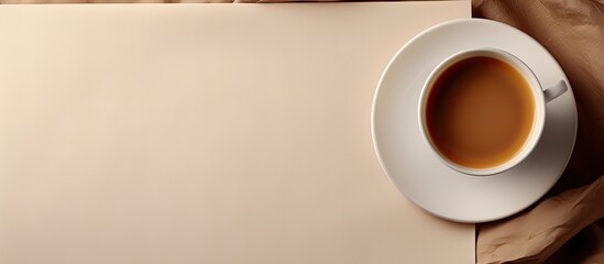 Poster - Copy space image of a coffee cup on a fabric background with a blank card and tray nearby