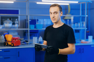 Engineer use computer tablet in industry lab for testing building materials. Controls quality of concrete cube, sand and brick in laboratory