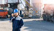 Worker use radio walkie talkie background concrete mixer truck. Construction man in hardhat working in Industry cement plant