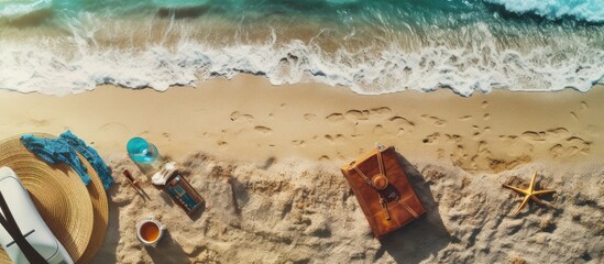 Poster - A travel concept is depicted from a top view perspective on an abstract beach background with various accessories Copy space image