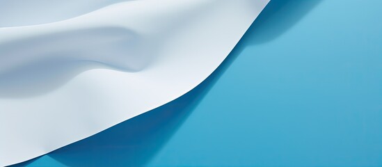 Aufkleber - A white sheet of paper is placed on a blue background providing ample copy space for text The image showcases a print design concept