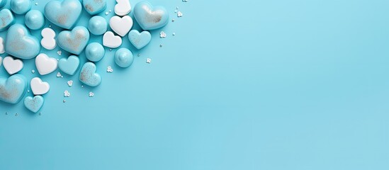 Fototapete - Pastel azure background with a heart shaped arrangement of blue sweet chocolates Flat lay top view Perfect for expressing love on occasions like Valentine s Day Mother s Day or a birthday card with c