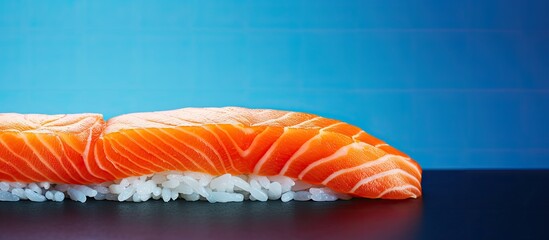 Poster - A panoramic photo captures a vibrant copy space image of delicious freshly prepared nigiri sushi featuring succulent pieces of salmon resting on a striking blue and orange surface