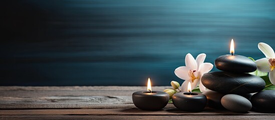 Poster - A serene arrangement of candles and spa stones on a wooden backdrop creates a captivating copy space image