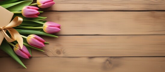 Aufkleber - A light wooden background serves as the perfect canvas for an arrangement of tulip flowers cards and gift boxes in this composition copy space image