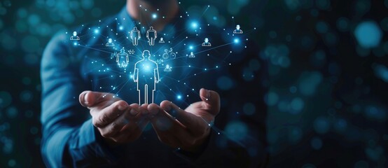 Businessman holding human icon and man icons on dark background with blue glowing effect, work team concept. Business network connection social media design.