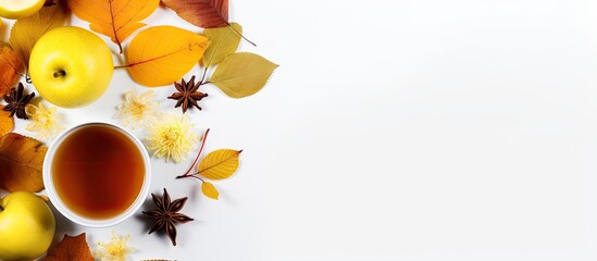 Sticker - Top view of a cup of tea adorned with lemon honey autumn leaves and apples placed on a white background This flat lay image captures the essence of autumn with ample copy space for any desired text