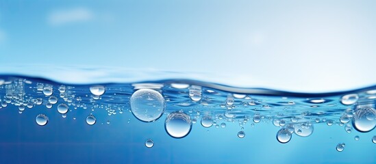 Poster - A vibrant macro abstract image showcases round bubbles of carbon dioxide floating in the translucent blue waters of the ocean providing ample copy space