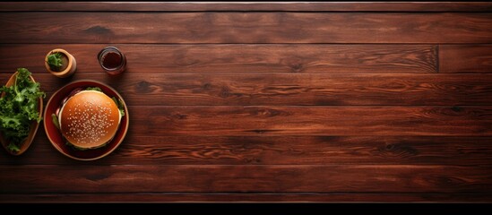 Canvas Print - A burger viewed from above with a wooden table and a black tray nearby Copy space image