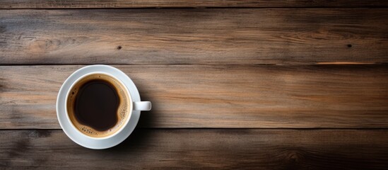 Aufkleber - A coffee cup viewed from above on a wooden table with a background for copy space image