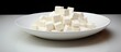 A white dish with chopped tofu presented for a food preparation photo showcasing a copy space image