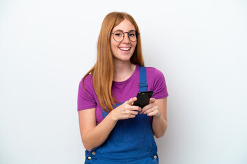 Wall Mural - Young redhead woman isolated on white background surprised and sending a message