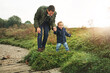 © peopleimages.com - Family, walking and father with baby in park for bonding, playing and laugh together outdoors. Nature, blue sky and happy dad with young boy for child development, love or fun on weekend or holiday