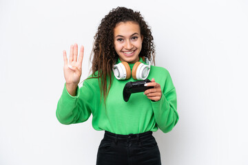 Wall Mural - Young Arab woman playing with a video game controller isolated on white background happy and counting four with fingers