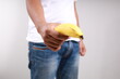 © ArvStd - Asian man holding a banana, Size matters concept and penis size measurement.