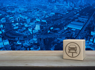 Wall Mural - Service fix car with wrench tool icon on wood block cube on wooden table over modern city tower, street, expressway and skyscraper, Business repair car service concept