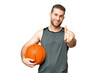 © luismolinero - Handsome young man playing basketball over isolated chroma key background showing and lifting a finger